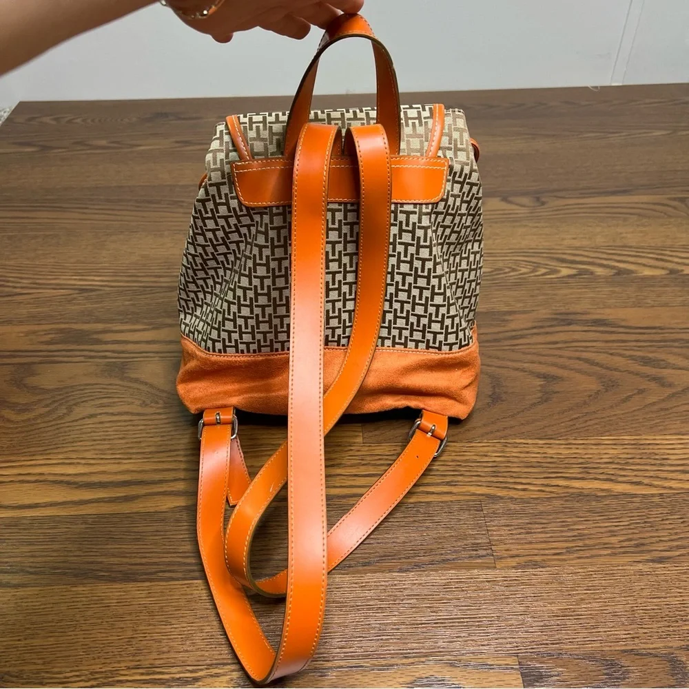 Tommy Hilfiger backpack in orange and brown with a monogram logo print